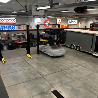 Spacious garage with car lifts, trailer, and vintage signs - Rob from Center Point, Iowa