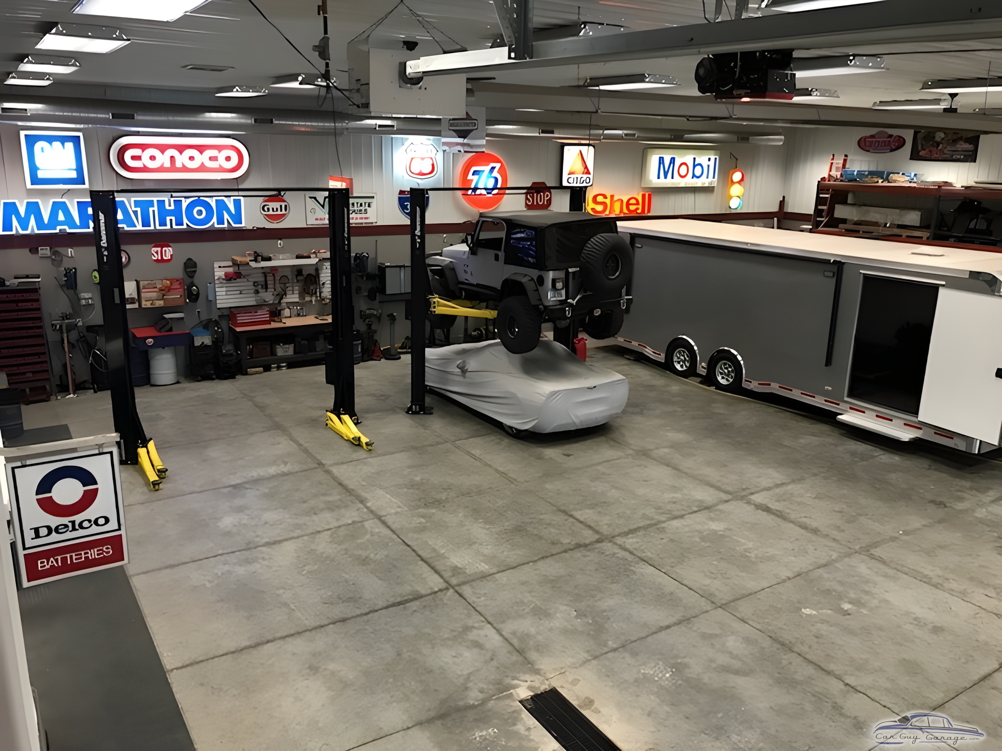 Spacious garage with car lifts, trailer, and vintage signs - Rob from Center Point, Iowa