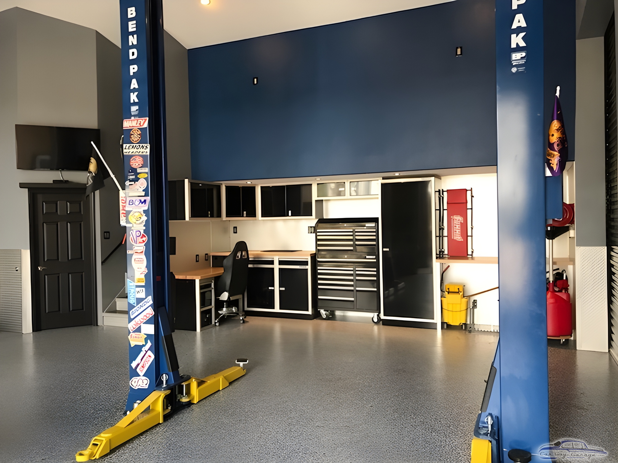 Organized garage with car lift, cabinets, and tool chest - P&J Motorsports from Parrish, Florida