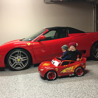 Red Ferrari and Kids Ride-On Car in Garage - RV from Argyle, Texas