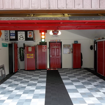 Organized garage with red cabinets and checkered flooring - PLY GUY from Indio, CA