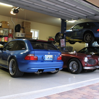 Organized garage with car lift, BMWs, and storage - Randy from Parrish, Florida