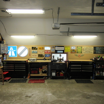 Organized garage with tool chests, metal signs, and shelving - David from Haslett, MI