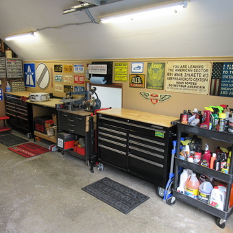 Organized garage with tool chests, workbenches, and signs - David from Haslett, MI