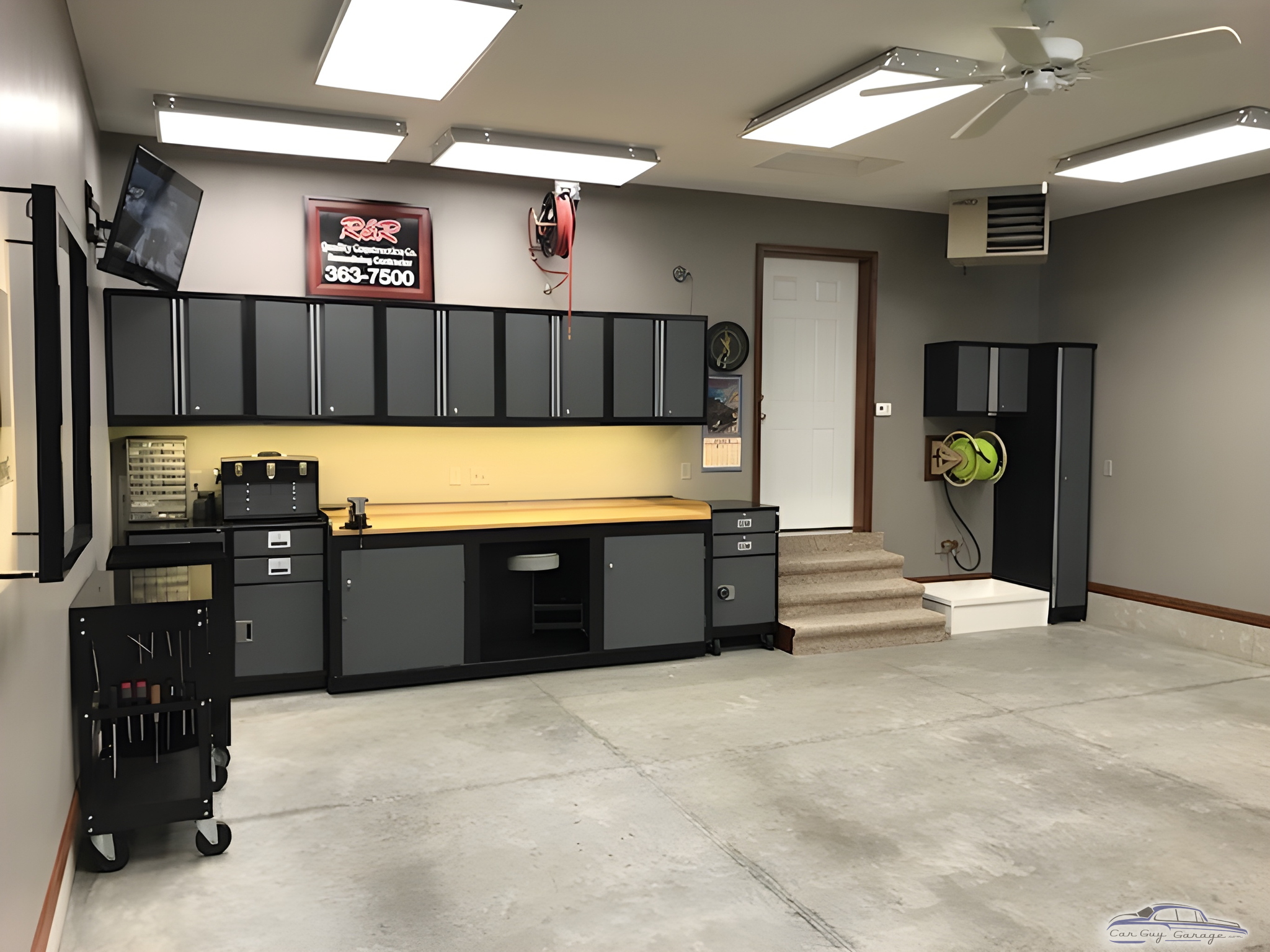 Modern garage with cabinets, workbench, and tool storage - Roger O from Center Point, IA