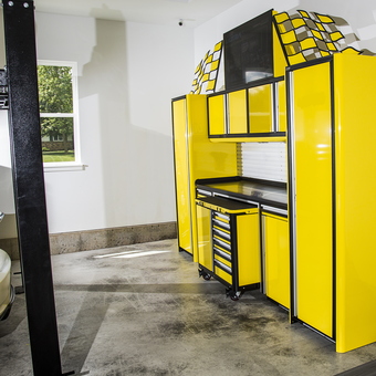 Yellow garage cabinets and car lift with workbench - Nate from Still Freezing, WI