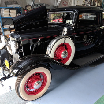 Classic Black Coupe with Red Spoke Wheels in Organized Garage - George from Inverness, Florida