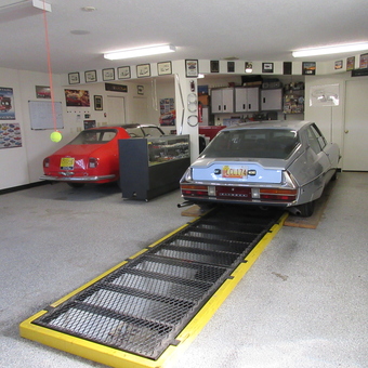 Organized garage with lift, cabinets, and car memorabilia - Joe from Placitas, NM