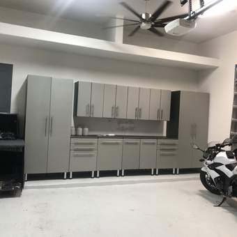 Modern garage with cabinets, motorcycle, and ladders - Jante from Bellaire, Texas