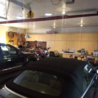 Organized garage with cabinets, workbench, and vehicles - Jefe from LARKSPUR, Colorado