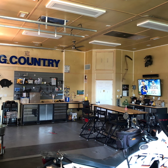 Organized garage with workbench, storage, TV, and bar - Peter Venables from Medicine Hat, Alberta