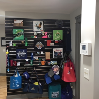 Garage Wall Display with Hooks and Bags - Same Day Tees Showroom from Franfort, IL