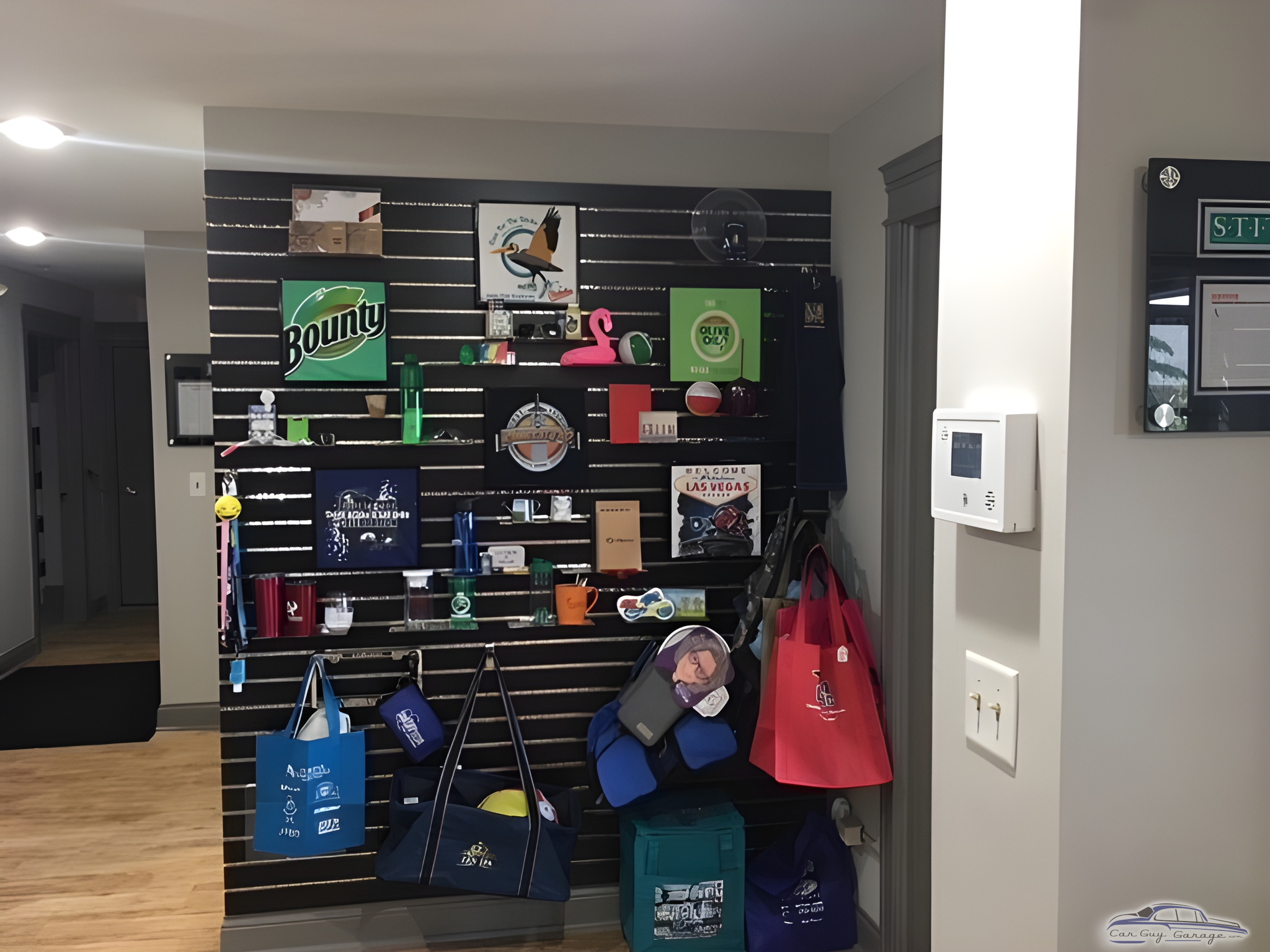 Garage Wall Display with Hooks and Bags - Same Day Tees Showroom from Franfort, IL