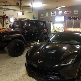 Organized garage with Jeep, Corvette, cabinets, and decor - Kirk C Cave from Loganville, GA