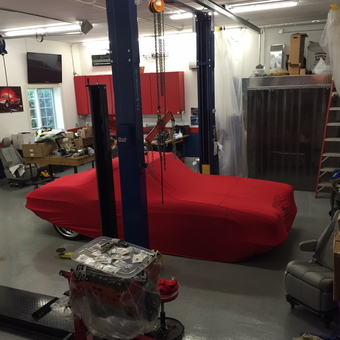 Organized garage with car lift, engine stand, and red cabinets - Tom from Valparaiso, Indiana