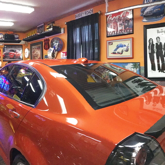 Custom Garage With Neon Signs, Texaco Decor, and Classic Car Art - Anonymous