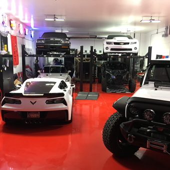 Custom Garage with Car Lifts, Neon Signs, and Tool Cabinets - MDB Garages