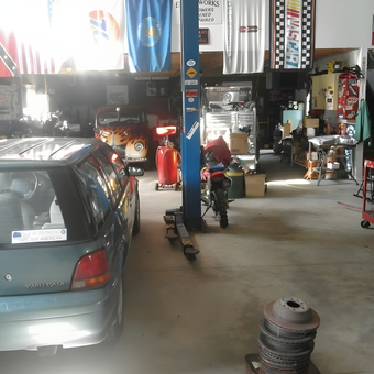 Organized garage with car lift, tools, and flags - Ron Kruty from Montville, OH