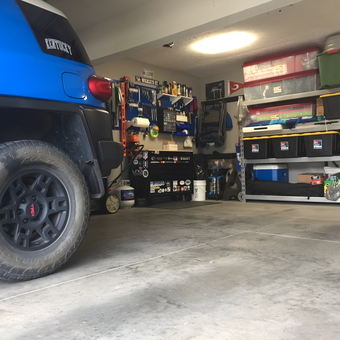 Organized garage with shelves, bins, and blue SUV - Brian from Louisville, KY