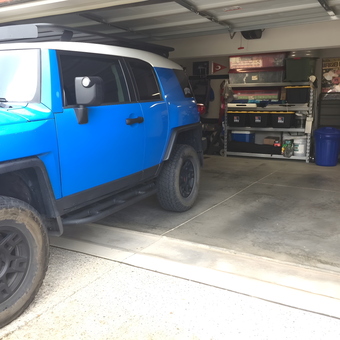 Organized garage with storage shelves and blue SUV - Brian from Louisville, KY