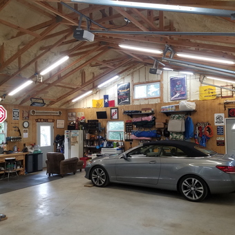 Organized garage with workbench, tool chest, and wall decor - Tom's Garage from Ellijay, GA