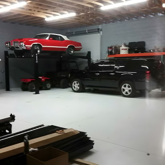 Spacious garage with car lift, shelving, and vehicles - Pete from Alva, FL