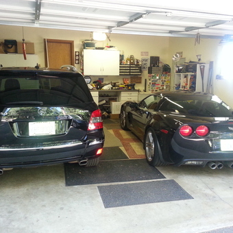 Organized garage with black cars, cabinets, and workbench - Marty from Pollock Pines, California