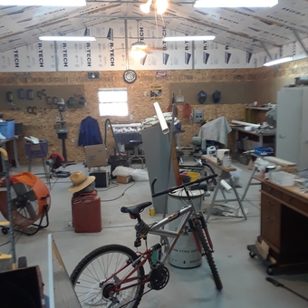 Organized garage workspace with tools, bike, and fan - 34 coupe guy from Joahua tree, California