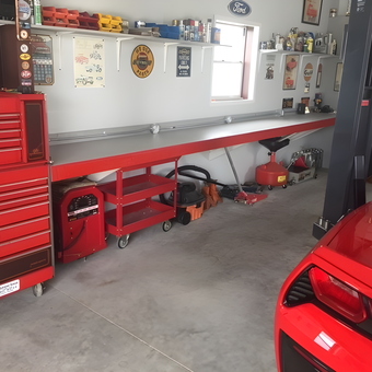 Organized garage with red tool chests and workbench - Dave's Garage from Port Charlotte, FL