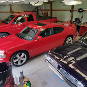 Organized garage with red Dodge vehicles and workbench - Pete from Fort Belvoir, VA