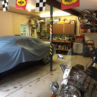Organized garage with car cover, motorcycle, and storage - Don from North East, Pa