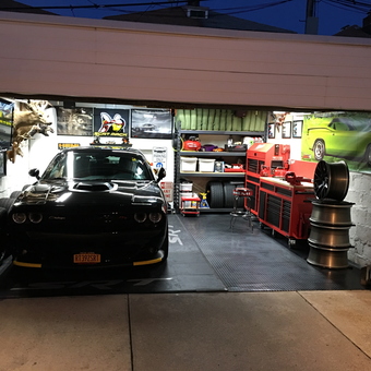Organized garage with Dodge Challenger, tool chests, and wall art - Where The *itch sleeps from Brooklyn, New York