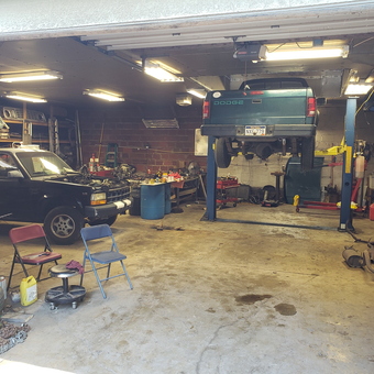 Organized garage with car lift, tool chests, and workbenches - Tater Hill from Martinsburg WV