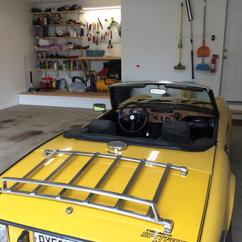 Organized garage with yellow convertible and wall shelving - Jimboga from Gainesville, GA