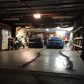 Spacious garage with cars, motorcycle, storage shelves - Dongview Garage from Hilliard, Oh