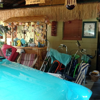 Tiki bar decor with classic car and bikes - Tiki Deluxe from Lafayette, IN