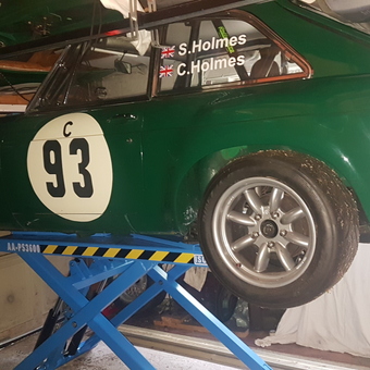 Green Race Car on Scissor Lift in Garage - HolmesRacing from Norwich
