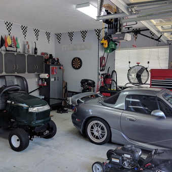 Organized garage with cabinets, tool chest, and vehicles - HomeGarageMan from Panama City, FL