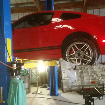 Red sports car on two post lift with transmission jack - JAMES from COATESVILLE, Indiana