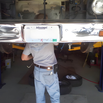 Car Lift with Mechanic Working Under Classic Vehicle - Thug Hunter from MO
