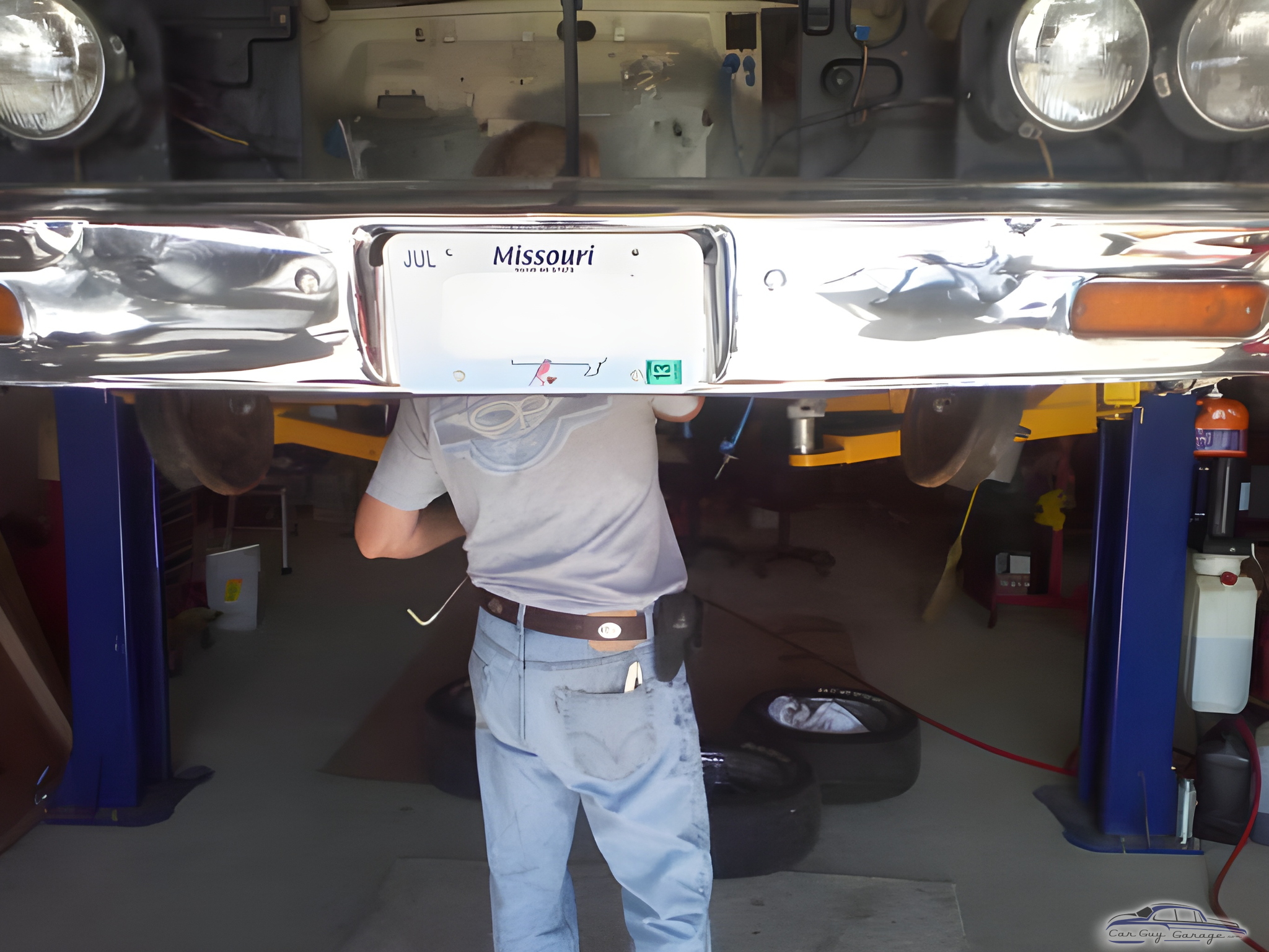 Car Lift with Mechanic Working Under Classic Vehicle - Thug Hunter from MO