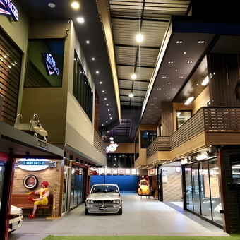 Modern garage with classic cars and neon signs - Heng from Bangkok