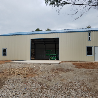 Large metal garage with blue trim and multiple windows - Bob from Dallas, TX