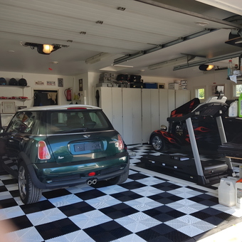 Custom garage with checkered flooring, cabinets, and Mini Cooper - Sakke from Nummela