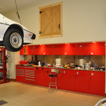 Garage With Car Lift and Red Cabinets - Brighton, CO