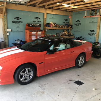 Organized garage with orange Camaro and tool chest - Ray from New Franklin, OH