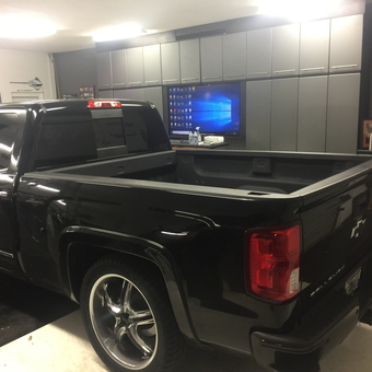 Modern garage with storage cabinets and black Chevy truck - Bossman from TAMPA, FL