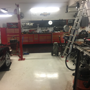 Organized garage with red tool cabinets and car lift - Bossman from TAMPA, FL
