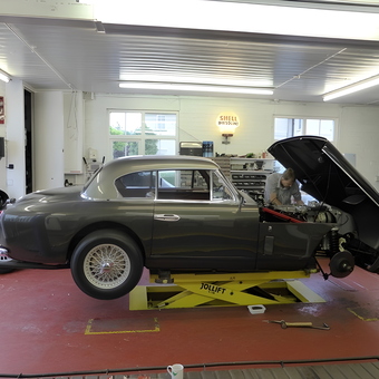 Classic car on mid-rise lift in organized garage - David