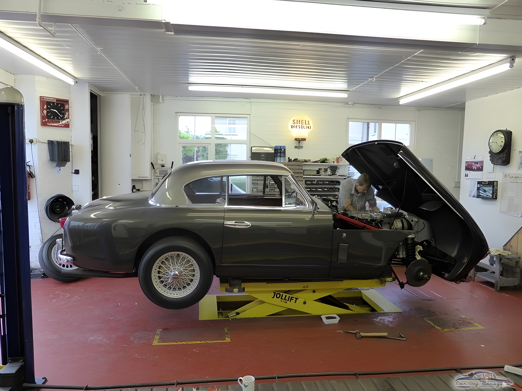 Classic car on mid-rise lift in organized garage - David